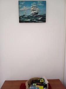 a painting of a ship on a white wall at Apartmani SAMB Igalo in Herceg-Novi