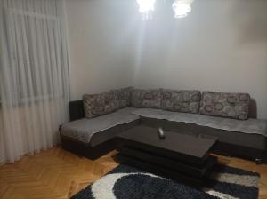 a living room with a couch and a coffee table at Maria's Place in Bitola