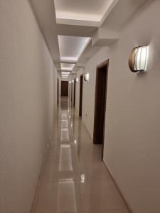 a long hallway with white walls and ceilings and a long hall at Agape Rose Hotel in Tivat
