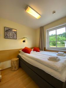 a bedroom with a large bed with a window at Lilland Brewery Hotel in Tau +60 photos