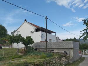 a white house on the side of a street at Misljen apartmants in Zadar