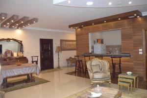 a large living room with a table and a kitchen at amazing apartment in the most luxurious area of ​​the Fifth Settlement in Cairo