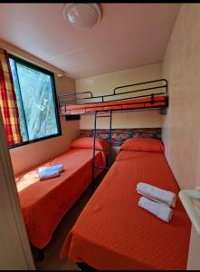 two bunk beds in a room with a window at Curmo beach & relax in Le Castella