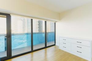a bedroom with large windows and a swimming pool at Batum Apart in Batumi