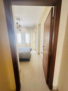 a hallway of a room with a bed and a door at Apartamento vacacional achakar playa&piscina! in Tangier