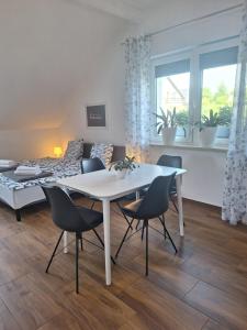 a living room with a white table and chairs at Apartament Victoria in Sarnowy