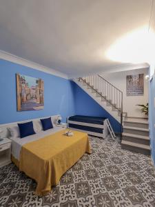 a bedroom with a bed and a staircase at La Bifora e il granaio in Sciacca