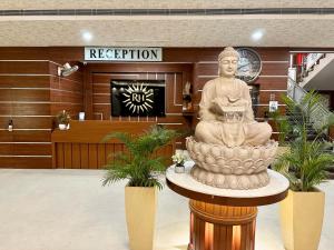 a large statue in a lobby of a building at Royal Heritage Hotel & Resort in Ayodhya