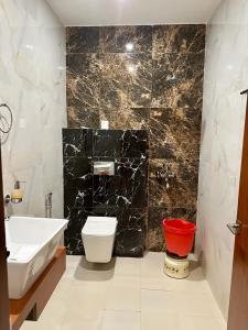 a bathroom with a sink and a toilet and a tub at Royal Heritage Hotel & Resort in Ayodhya