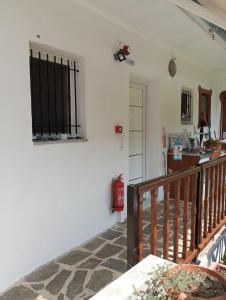 a living room with a staircase and a window at Perivoli Tessas' in Parga