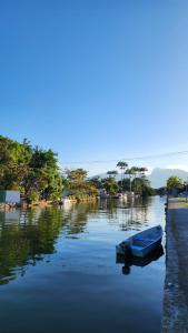 a blue boat sitting in the middle of a river at Toca da Tulipa in Paraty +3 photos
