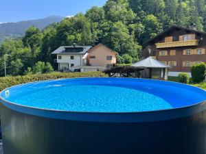 a large blue swimming pool in front of a house at Haus Stofleth in Tschagguns