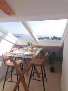 a dining room with a table and chairs at Sky apartment, Island Rab in Rab +6 photos