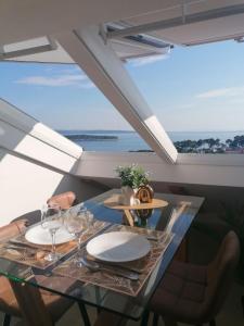 a dining room with a table with wine glasses at Sky apartment, Island Rab in Rab