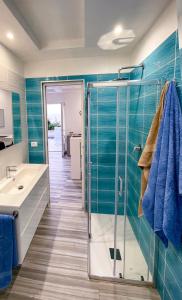 a bathroom with a glass shower and a sink at barracudasuite in Ischia