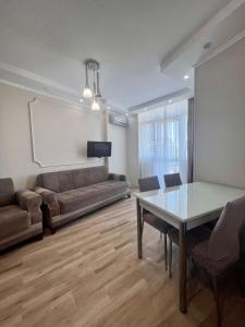 - un salon avec un canapé et une table dans l'établissement Luxure Apartments, à Batoumi