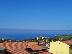 a view of the ocean from the roofs of houses at Appartamenti Miramare in Marina di Camerota