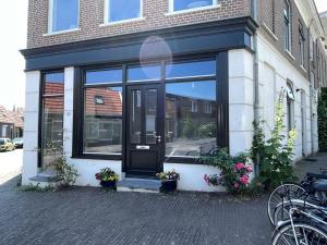 a store front with a black door and some flowers at Studio in Arnhem