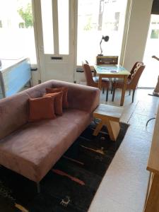 a living room with a couch and a table at Studio in Arnhem