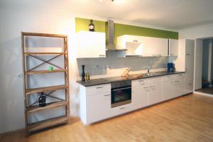 a kitchen with white cabinets and a ladder in it at Gala Apartments - Country Oasis in Pettenbach in Pettenbach