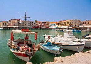 two boats are docked in the water in a harbor at Elysian Rose Residence in Rethymno Town