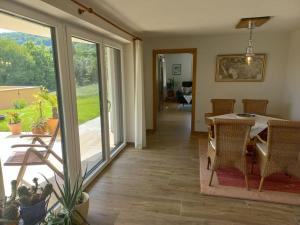a dining room with a table and a balcony at Haus Sylvia in Frutten