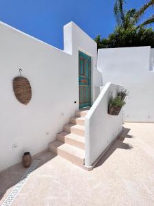 a white house with a staircase and a door at Atalaya Boutique in Denia