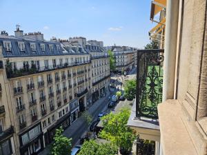 a view of a city street from a balcony at Hôtel Bellevue et du Chariot d'Or in Paris