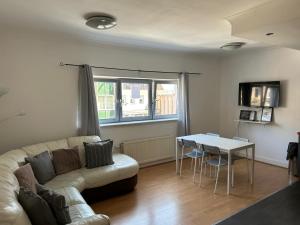 a living room with a couch and a table at Apex Variety Gate Apartment in Glasgow