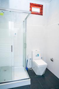 a bathroom with a glass shower and a toilet at Thisha Hotel & Restaurant in Jaffna +47 photos
