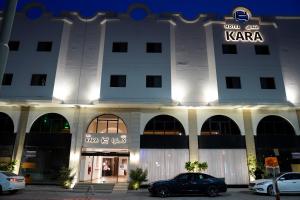 a building with a car parked in front of it at Kara Hotel فندق كارا in Al Khobar