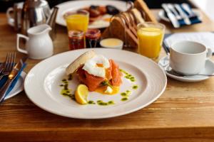 a plate of food on a table with orange juice at The Randolph Hotel in Southwold