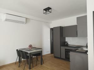 a kitchen with a table and chairs in a room at Coral Reef Apartments in St. Paul's Bay