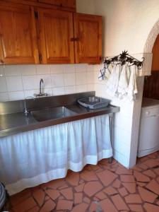 a kitchen with a sink and a counter top at Thekwane Holiday House in Klipdrift