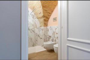 a bathroom with a white toilet and a sink at Al Miracolo in Lanciano