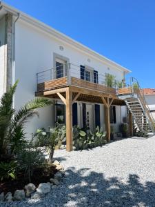 a house with a deck on the side of it at Escapade Ocean in Labenne