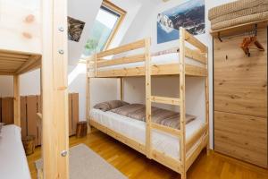 a bunk bed room with two bunk beds at Alpine Base Kranjska Gora in Kranjska Gora