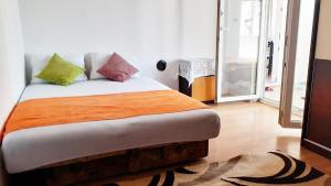 um quarto com uma cama com almofadas coloridas em Joli apartaments Kumbor em Kumbor