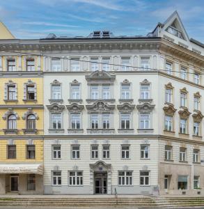 a large white building with many windows at The 77 EMMA in Vienna
