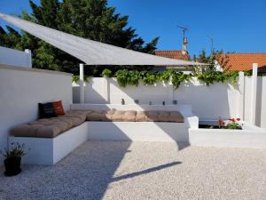 a white patio with a bench and a white fence at Air marin in La Bernerie-en-Retz