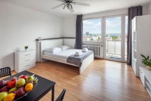 a bedroom with a bed and a table with a bowl of fruit at Sleepy3city with Sea View II in Gdynia