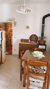 a kitchen with a table and chairs and a refrigerator at Casa nella roccia in Roccastrada