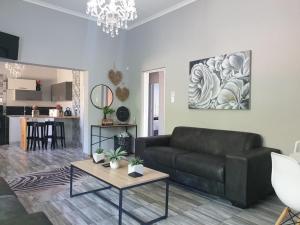 a living room with a couch and a table at ikibiki in Beaufort West