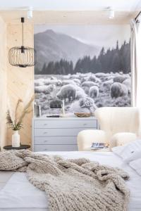 a bedroom with a herd of sheep in a field at Willa Bór in Zakopane