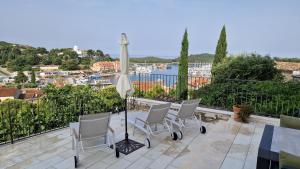 a patio with a table with chairs and an umbrella at Ferienhaus Topic in Vrsar