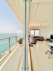 a living room with a view of the ocean at Luxurious 2 bedroom Beachfront Apartment - direct seaview in Ras al Khaimah