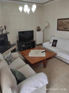 a living room with a couch and a coffee table at ANNASHOUSE in Nea Peramos +7 photos