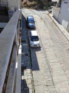 two cars parked on the side of a street at ANNASHOUSE in Néa Péramos