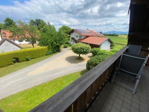 a balcony with a view of a house at Ferienwohnung Baumgartner Chiemseeliebe 2OG in Breitbrunn am Chiemsee