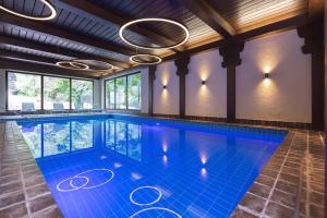 an indoor pool with blue tiles in a building at Das Hohenried in Freudenstadt